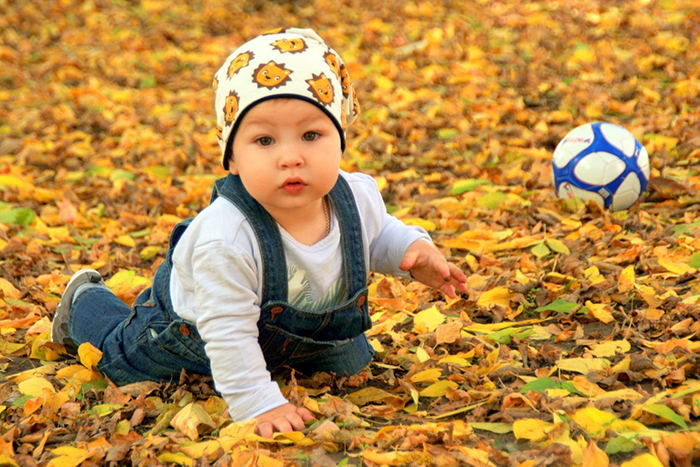 Male baby twin with ball